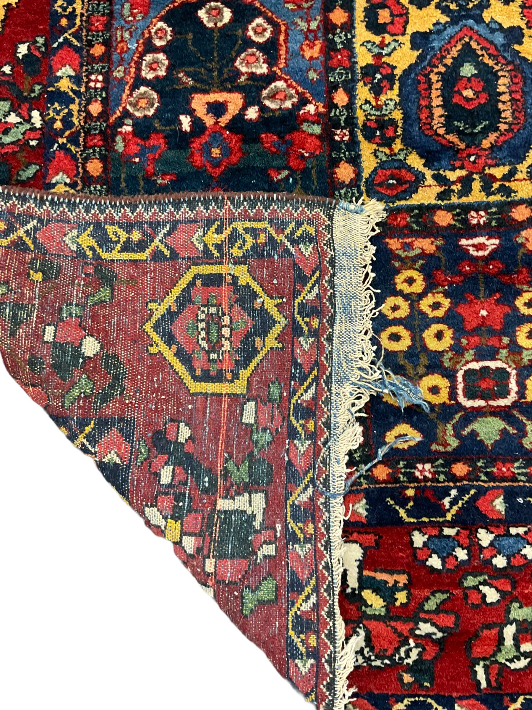 Large Persian garden rug, multiple rectangular panels decorated with stylised plants, Boteh and tree of life motifs, the outer guarded border with floral design 