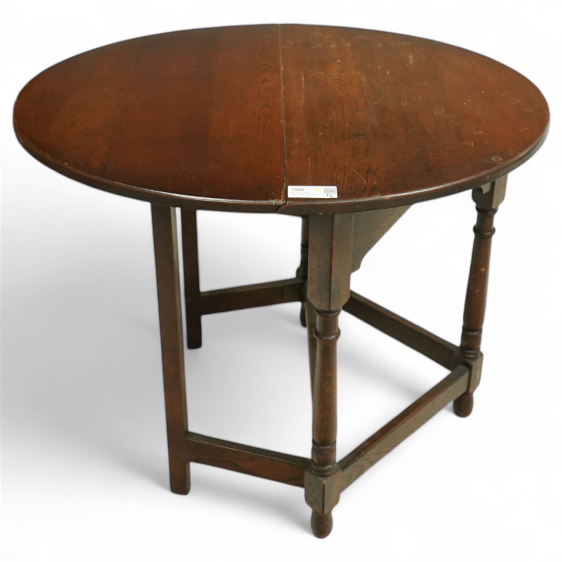 20th century oak drop-leaf table, of gateleg form with oval top, raised on turned legs and stretchers with twin gate supports