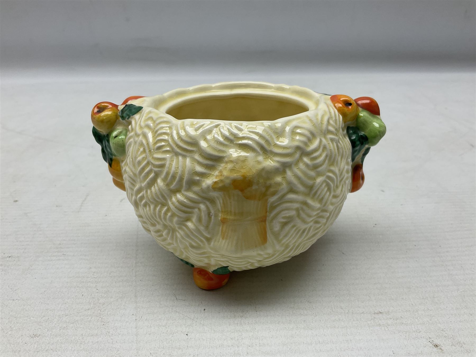 Clarice Cliff Celtic Harvest pattern sugar bowl, with original silver plate cover upon basket weave effect spherical body decorated with raised stylised fruit, H11cm