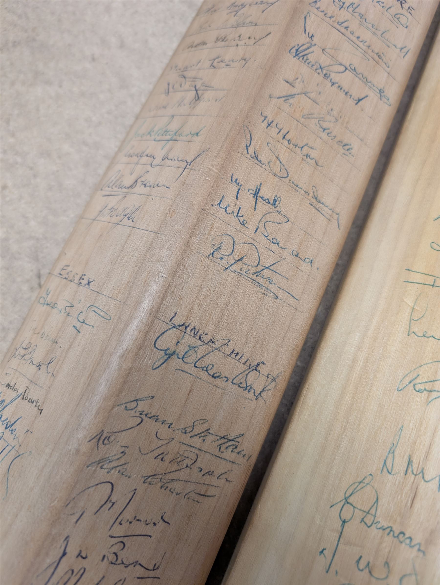 Two signed cricket bats, with signatures including Colin Cowdrey