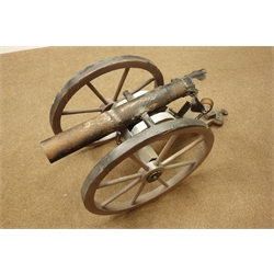  Cast iron model of a canon on wooden frame, L114cm   