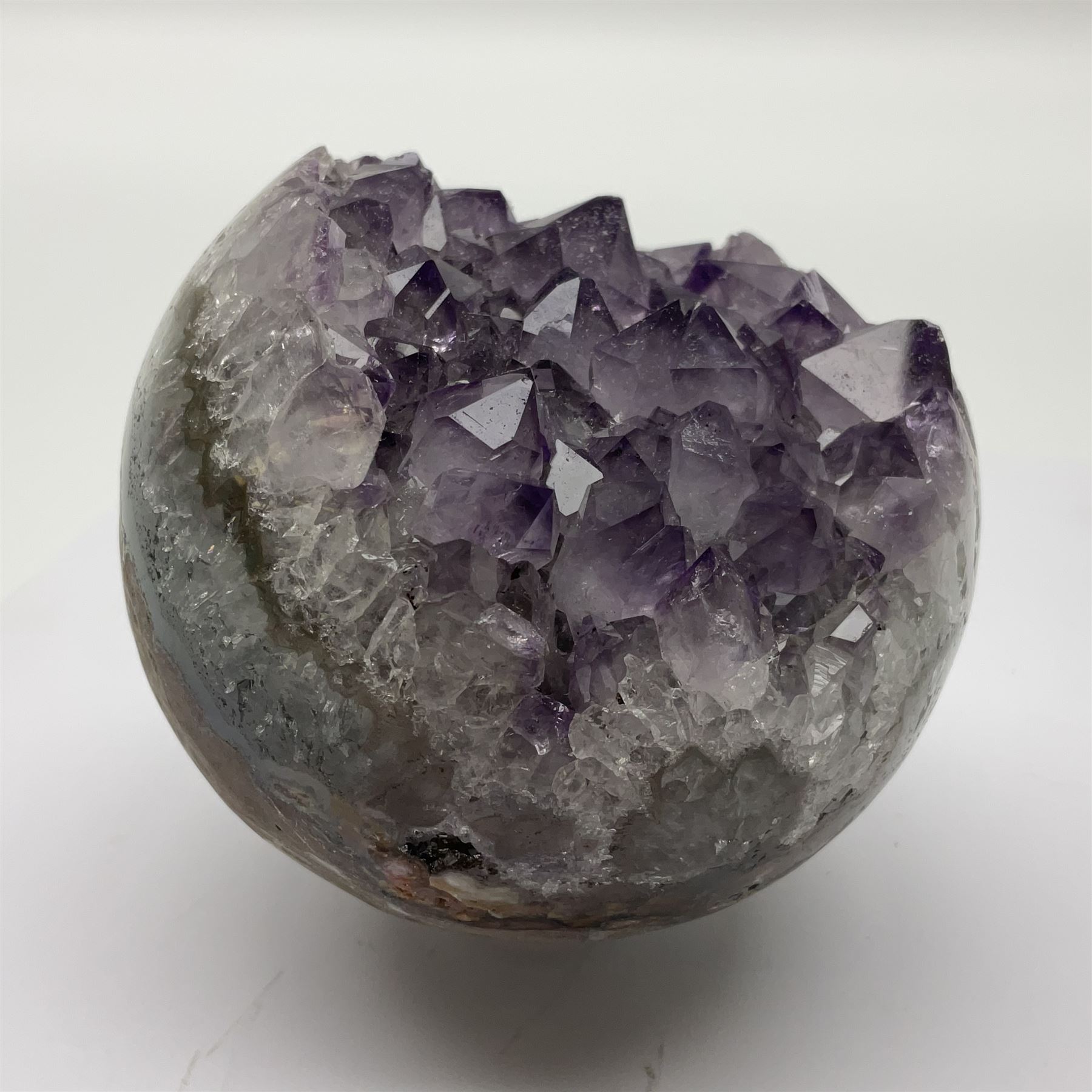 Pair of amethyst geode spheres, with purple crystalline internal formations, D9cm