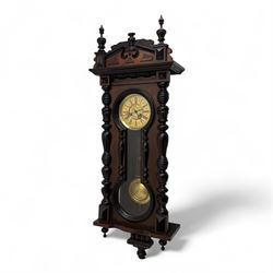 German- 19th century 8-day spring driven wall clock in a mahogany case with turned finials...