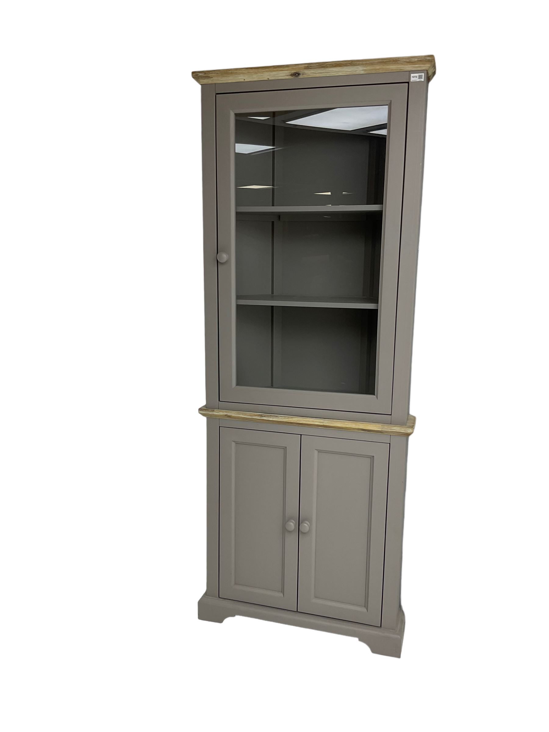 Contemporary teal and oak finish corner cabinet, single glazed door enclosing two shelves, over two panelled cupboard doors