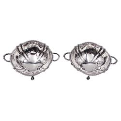Pair of small 1920's silver footed bowls, each of shaped circular form with husk rim and twin handles, upon four paw feet, hallmarked Ellis & Co, Birmingham 1922, H.5cm D9.5cm, approximate weight 4.10 ozt (127.4 grams)