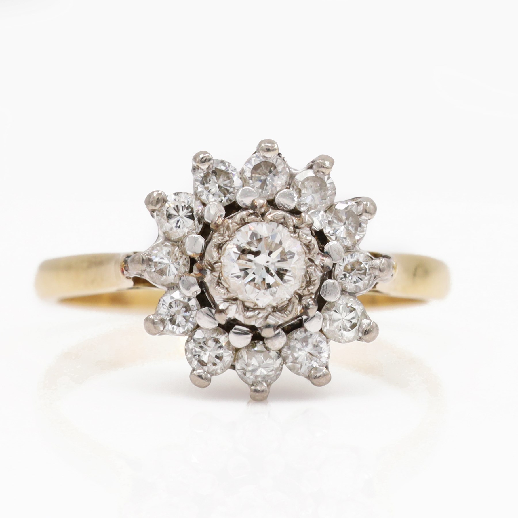 Gold diamond flower head cluster ring, single round brilliant cut diamond, surrounded by twelve further diamonds, stamped 18ct