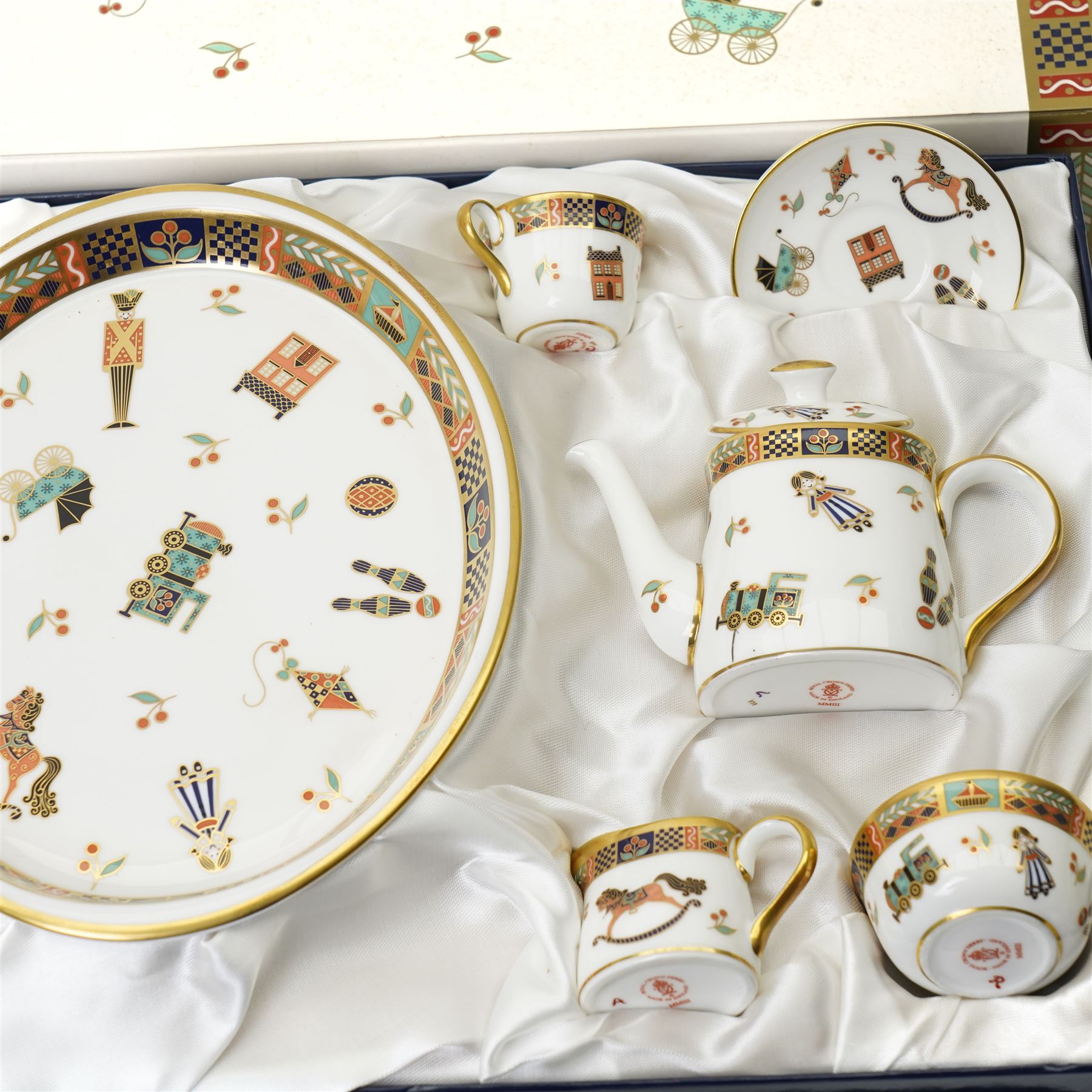 Royal Crown Derby 'Treasures of Childhood' miniature tea service, together with Humpty Dumpty figure, ragdoll, mug, and miniature sugar bowl, all boxed 
