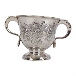 George I silver porringer, of typical form with flat capped twin curved handles,  the body with later presentation engraving surrounded by later embossed foliate decoration, upon a spreading circular foot, hallmarked Sarah Holaday, London 1723, H10.5cm