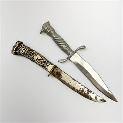 20th century hunting knife with 13cm single edge blade, cast white metal hilt with S-shaped quillon, wrythen grip and eagle head pommel L25cm overall; and another hunting knife with Solingen 12cm blade and simulated stag antler grip, both in leather sheath (2)