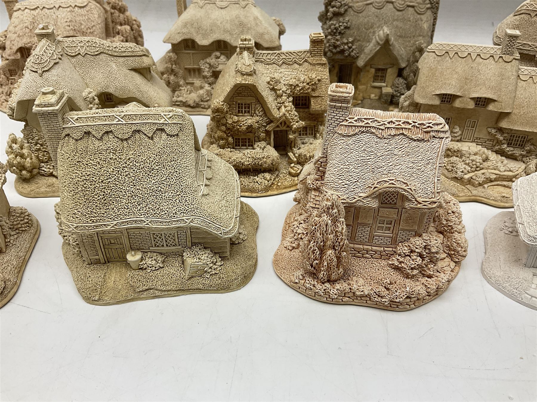 Twenty-three Lilliput Lane models from the Paint Your Own collection, to include Catmint Cottage, Sugar and Spice, Gypsy Cottage, Ruby Cottage and Little Birch, some boxed