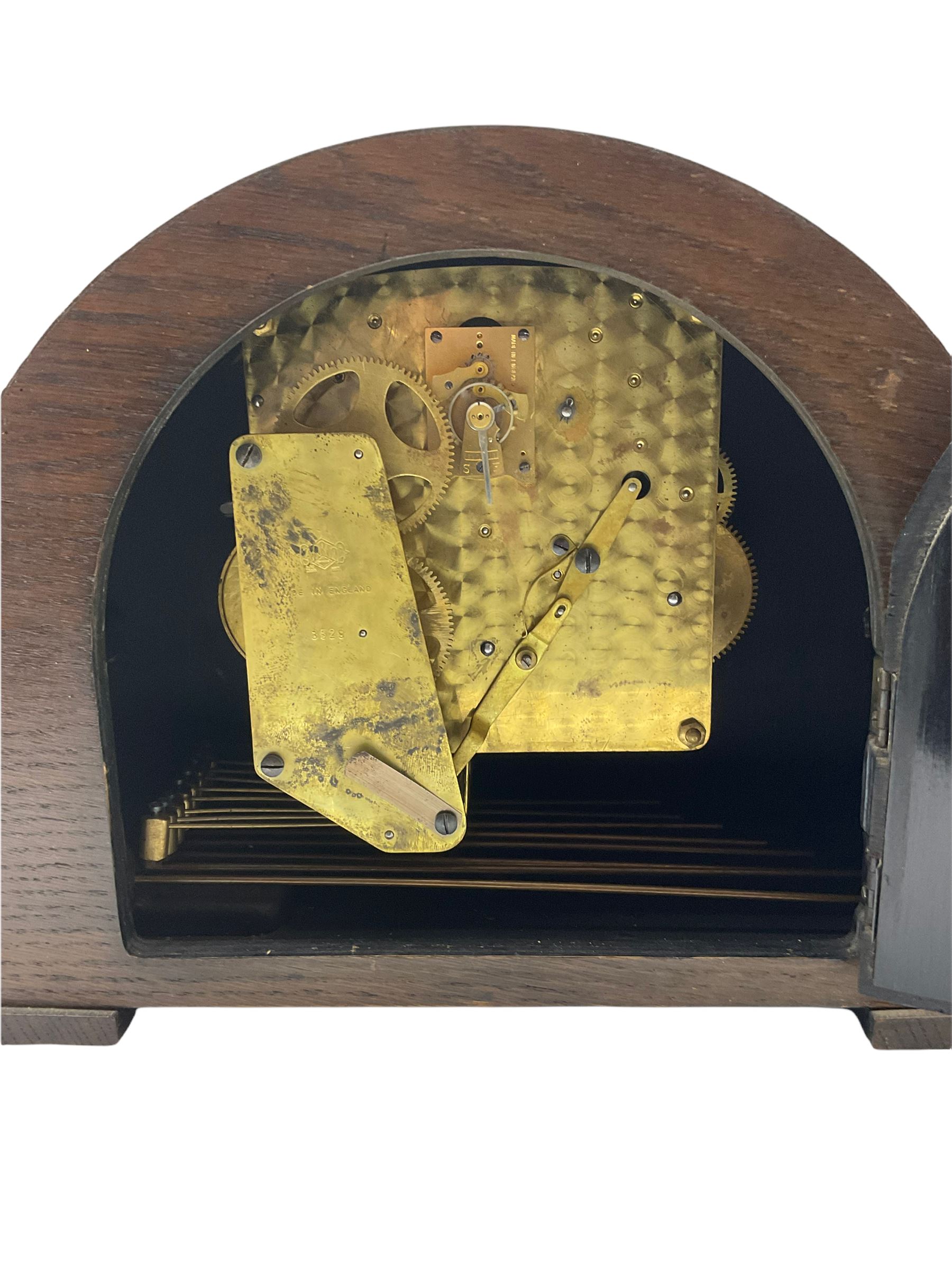 An English chiming mantle clock by Walker & Hall in an arched oak case