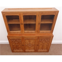  Mid to late 20th century light oak Gothic Revival wall unit, three glazed doors above three panelled cupboards, arcade and lunette carved doors with tracery work, W107cm, H120cm, D64cm  