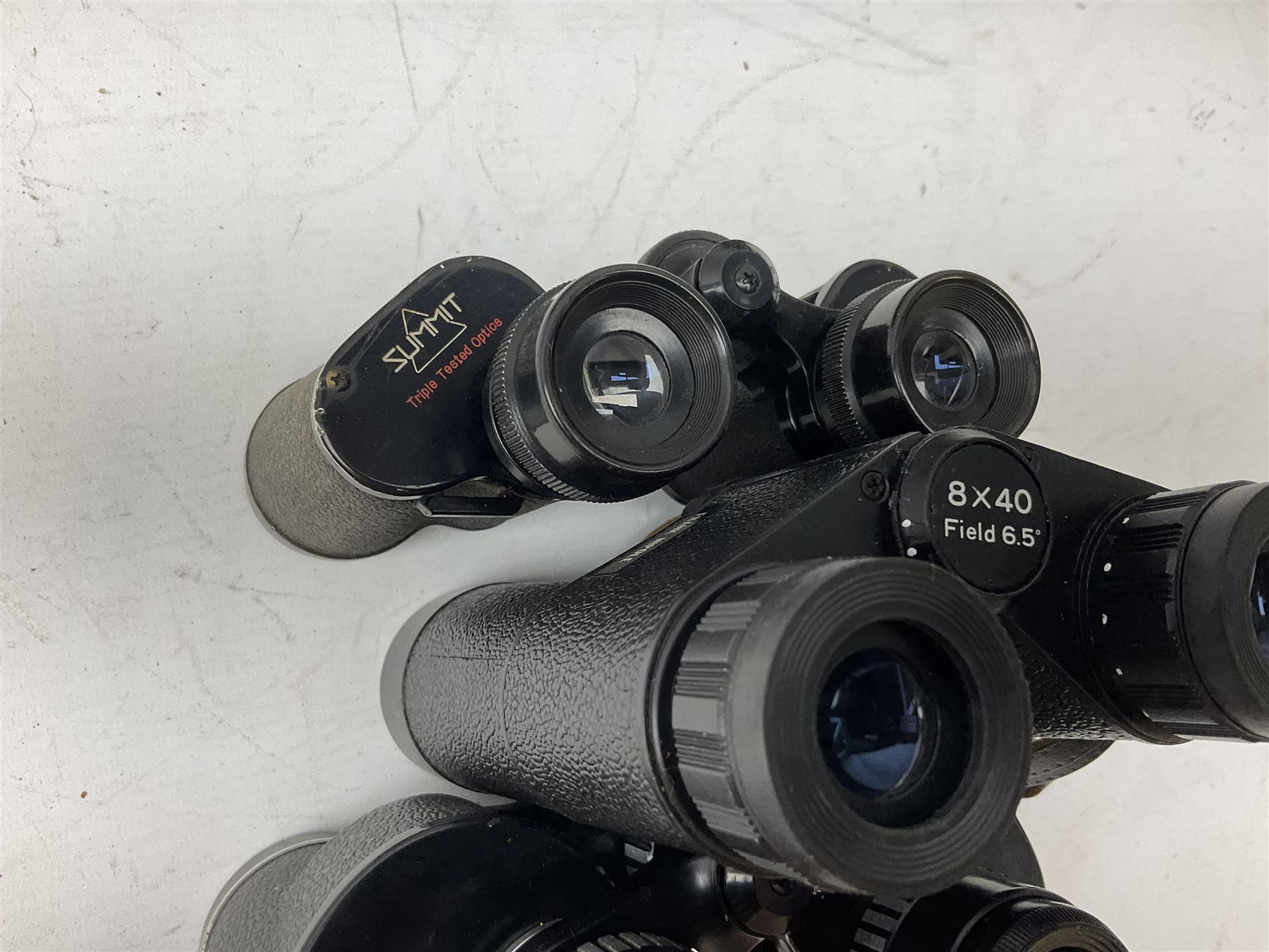Eleven cased pairs of binoculars to include Summit 8x30,  Concord 8x40, Tasco no. 106 8x - 16x40, Chinon 10x50, Tokina 7x42 Field, Zoom 6x- 12x32 etc