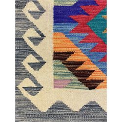 Anatolian Turkish Kilim rug, multi-coloured ground, decorated with geometric stepped lozenges with in a scrolled border