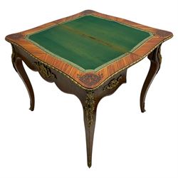 20th century French walnut and Kingwood card table, shaped fold-over top with figured quarter-matched veneers and floral egg and dart moulded edge in gilt metal, shaped aprons decorated with shell motifs with extending foliage, pull-out action base revealing storage well, on cabriole supports with ornate gilt metal mounts 