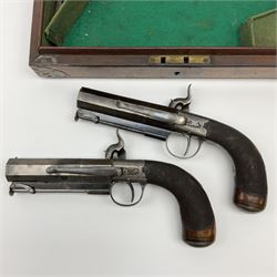 Pair of Richardson Liverpool 16-bore single barrel percussion belt/travelling pistols, each with 10.5cm plain octagonal barrel, under barrel swivelling captive ramrod, engraved action, trigger guard and hammer, chequered walnut grip with concealed butt compartment for ball/cap and open silver cartouche, L23cm overall; in green baize lined brass bound mahogany fitted case with inset carrying handle containing small copper powder flask, screw-driver, wrong bore steel scissor action bullet mould and two F. Joyce & Co percussion cap tins, case L30.5cm
