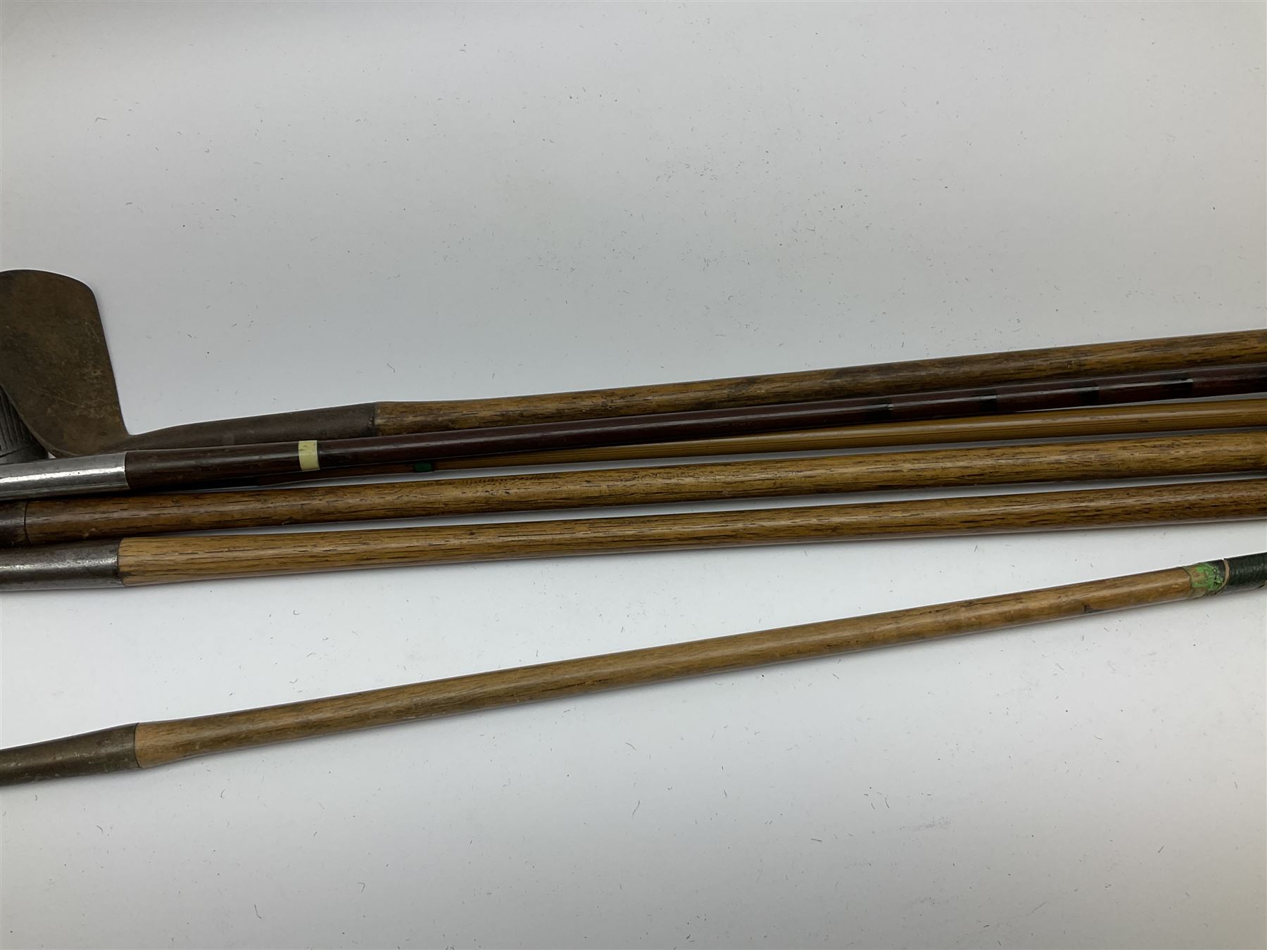 Golf - three early 20th century hickory shafted irons marked R. Simpson, Harrods Ltd etc; child's wooden shafted putter; two transitional wood grain steel shafted irons, one marked Tom Morris; and set of four Macgregor Tommy Armour woods (10)