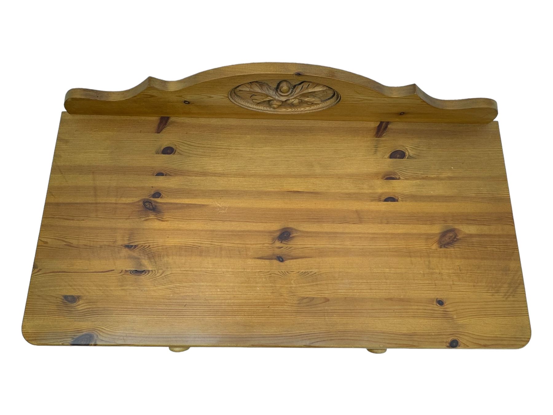 Pine chest of drawers topped with carved pediment with acorn and oak leaf motif, fitted with two short over three long drawers, standing on shaped apron base (W92, D46, H97cm); pine bedside cabinet, single drawer above paneled cupboard door enclosing open storage, shaped plinth base (W43, L32, H67cm)