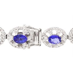 18ct white gold tanzanite and diamond bracelet, twelve oval link clusters set with oval cut tanzanite's and round brilliant cut diamonds, stamped 750, total tanzanite weight approx 7.15 carat, total diamond weight approx 4.00 carat
