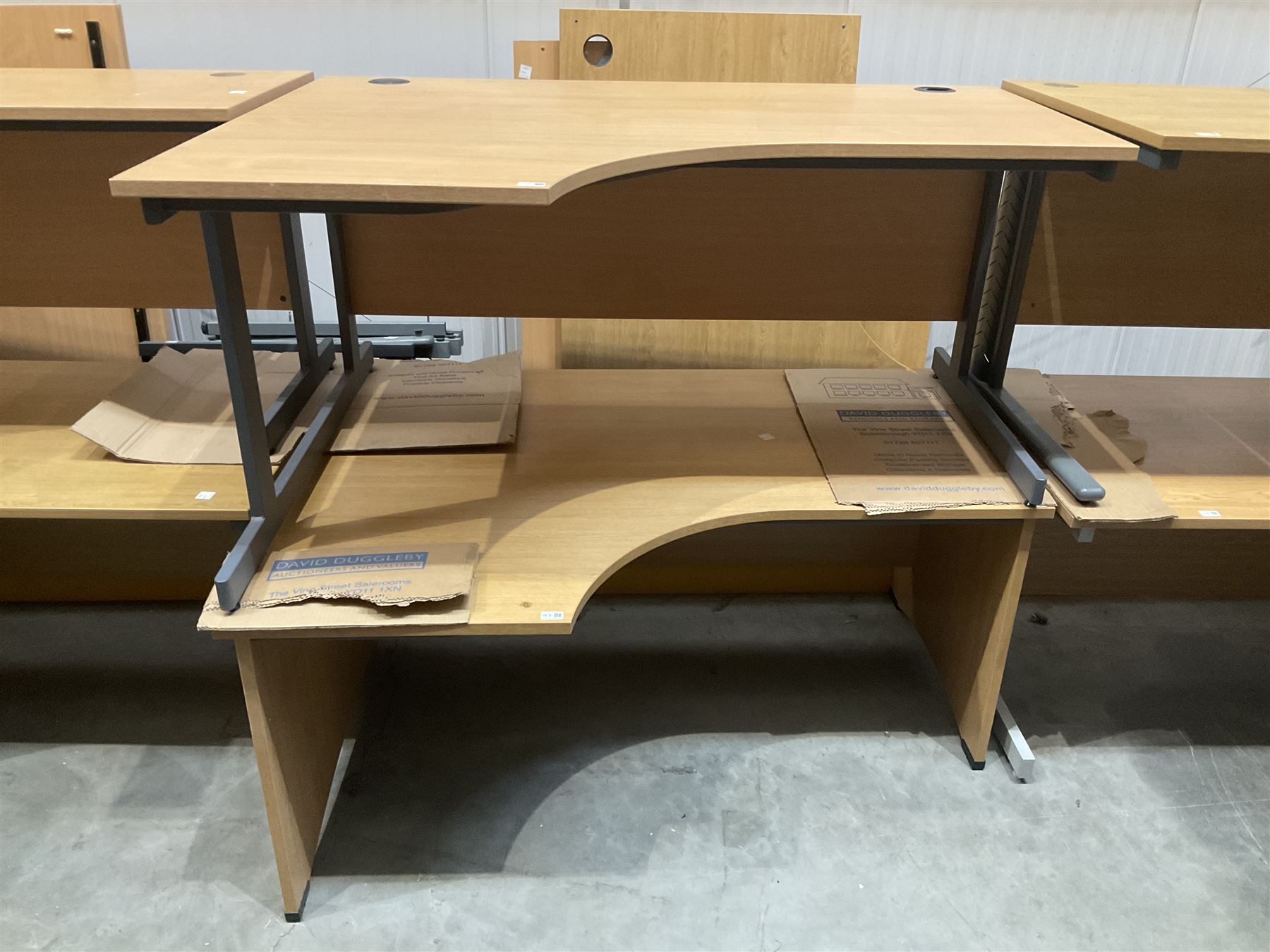 Pair of left hand return oak effect office desks. THIS LOT IS TO BE