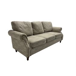 Three seat sofa, upholstered in grey fabric, scrolled arms with stud detail , raised on turned feet