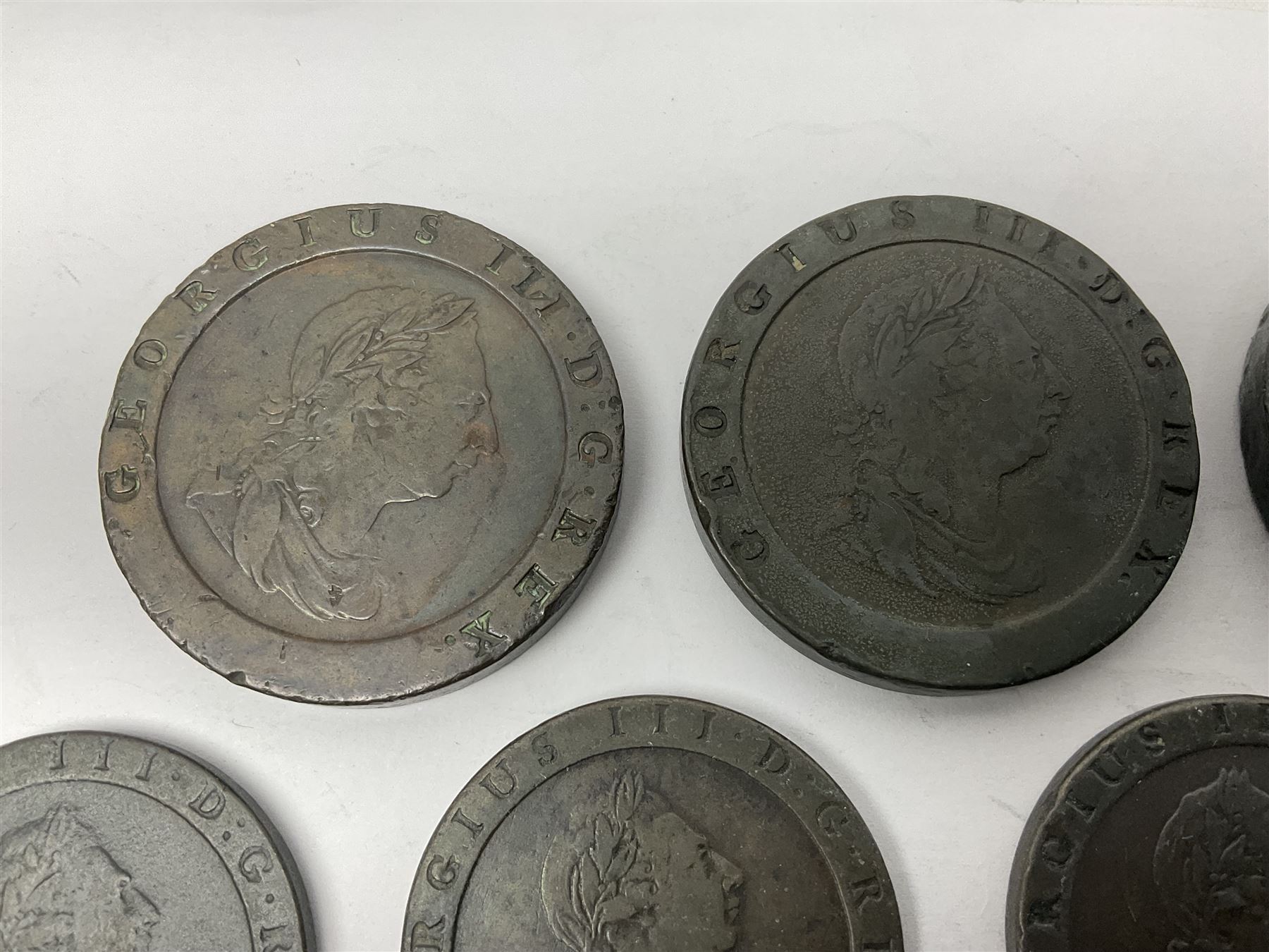 Two George III halfpenny coins dated 1799 and 1806, four pennies dated three 1806 and 1807, four 1797 cartwheel pennies and three 1797 cartwheel two pence coins