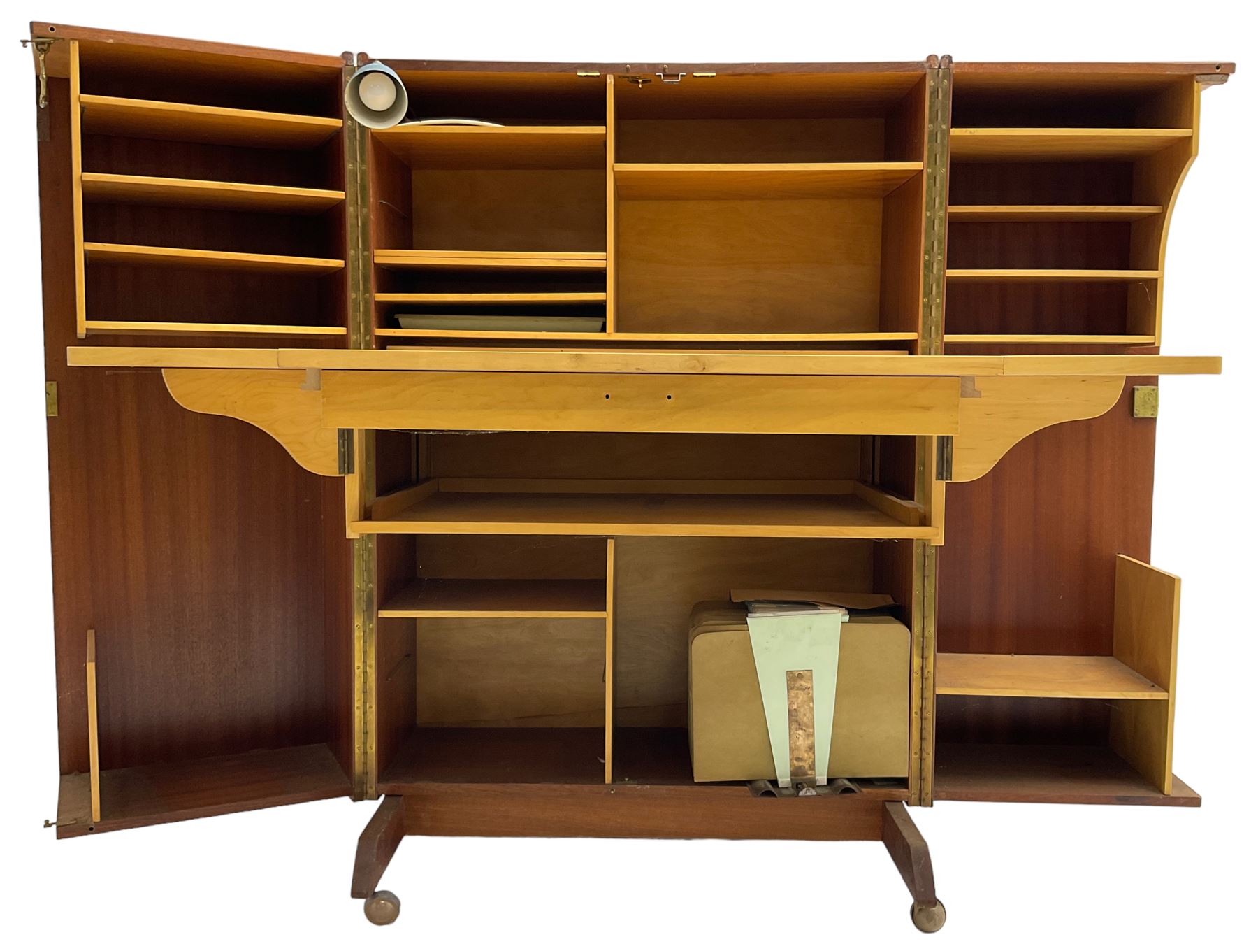 Mummenthaler & Meier - mid-20th century circa. 1960s teak 'Magic Box' folding desk cabinet, the cabinet opens to reveal shelves, writing desk, document holders and lamp, on castors