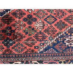 Persian Joshgan red ground rug, the medallion, field and spandrels decorated with clusters of Pitrak and tree of life motifs, the border with repeating design decorated with stylised plant motifs, within guard stripes