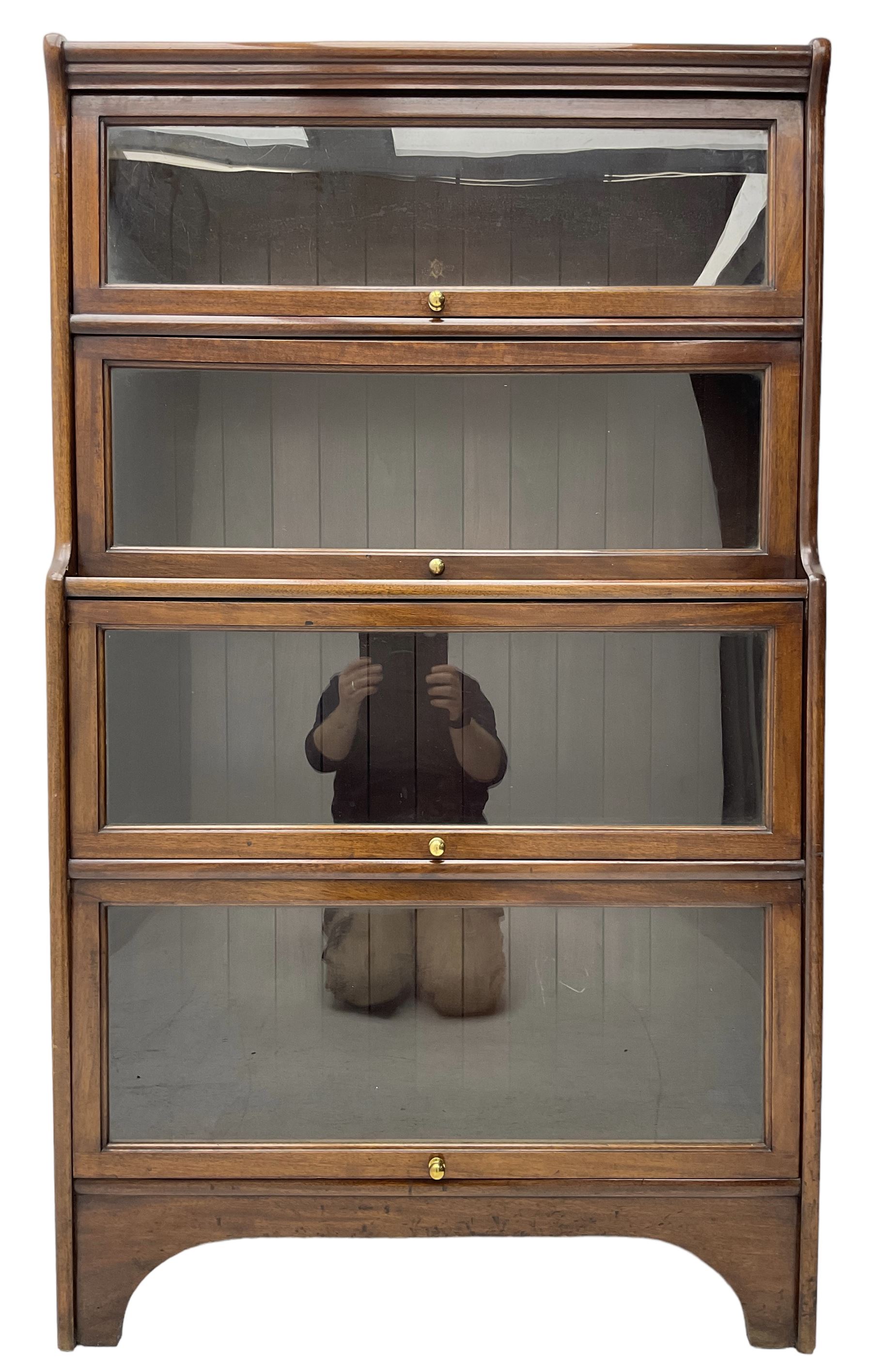 Kenric Efferson - early 20th century mahogany four-tier library bookcase, enclosed by four glazed up-and-over doors, on bracket feet