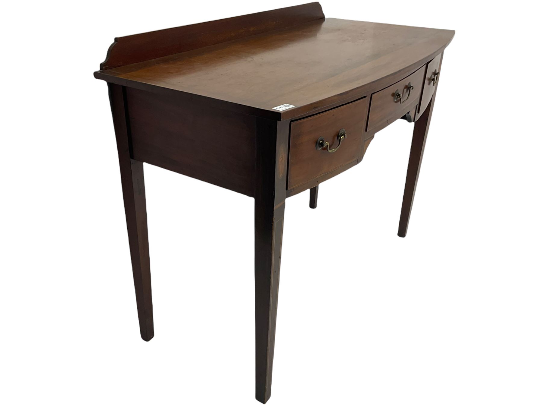 Edwardian mahogany dressing side table, raised back on bow front top with satinwood band, fitted with three drawers, inlaid with shell and fan motifs, square tapering supports