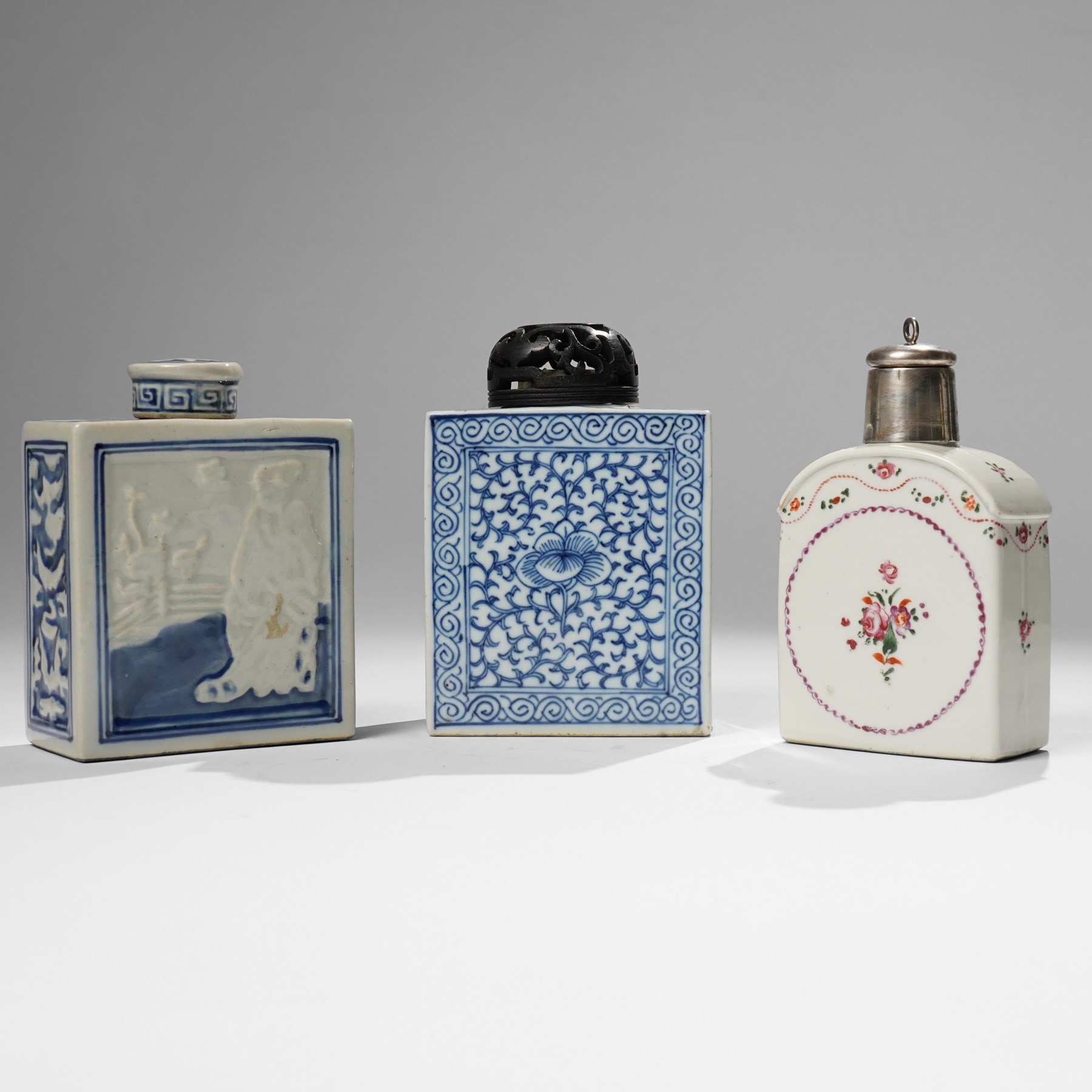 Two Chinese blue and white tea caddys, and another with famille rose design and engraved metal lid, larger H16cm (3)