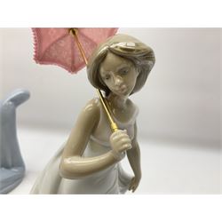 Four Lladro figures, comprising Afternoon Promenade no 7636, Nostalgia no 5071, both with original boxes, Girl with Lilies no 4972 and Madonna no 4534, largest example H27cm