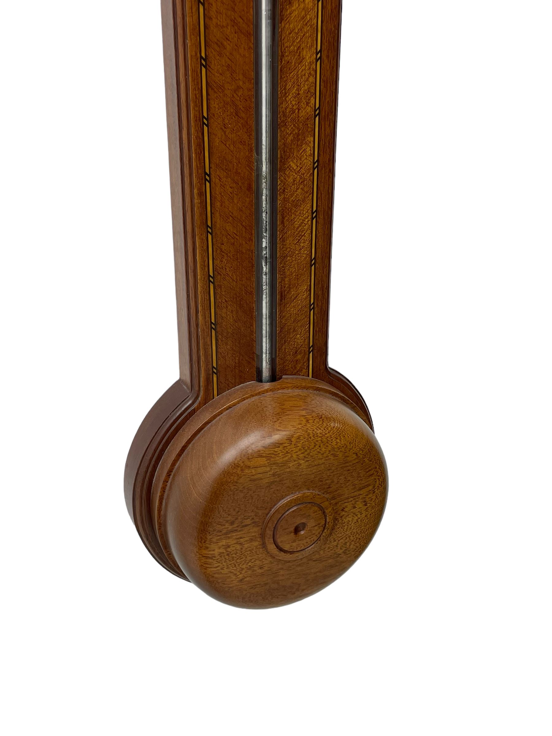 20th century - mercury cistern barometer in an 18th century style mahogany case with contrasting inlay and a broken pediment, round base with a turned cistern cover, fully exposed glass tube and silvered register within a glazed door, with a Fahrenheit spirit thermometer, engraved weather predictions and sliding vernier. Mercury clean and present.
