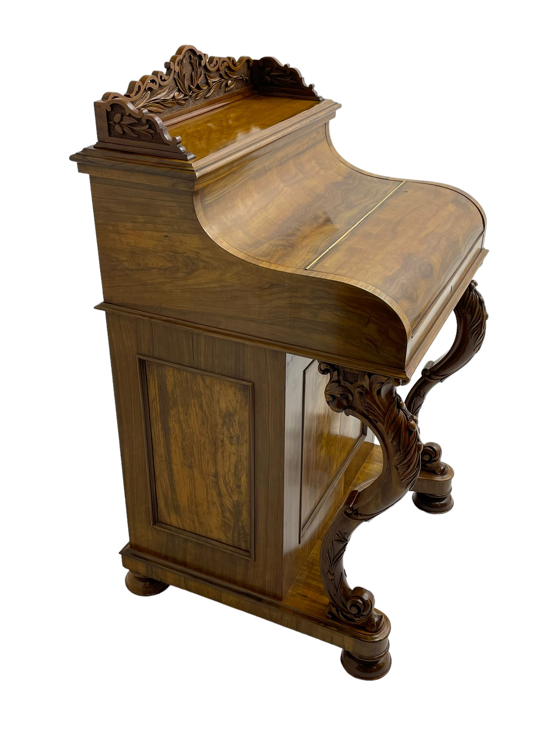 Fine and unusual 19th century olivewood piano top davenport, raised shaped back carved with olive branches and olives, the top hinges to reveal lidded and correspondence compartments, the piano lid enclosing sliding top with hinged and adjustable writing surface with leather inset, right-hand panelled door enclosing four drawers, olive branch and scroll carved cabriole front supports on moulded and shaped platform, turned cup feet with recessed castors 