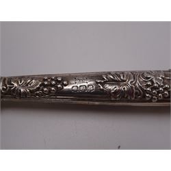 Set of 1930s silver handled fruit knives and forks, for six place settings, the handles decorated in relief with fruiting vines, hallmarked Walker & Hall, Sheffield 1934, together with a set of six 1920s silver egg spoons, with pin prick engraving to handle, hallmarked Thomas Bradbury & Sons Ltd, Sheffield 1929, in fitted case, three silver napkin rings, to include a pair, of octagonal form, with floral engraving, hallmarked John Rose, Birmingham 1951 and two silver souvenir spoons