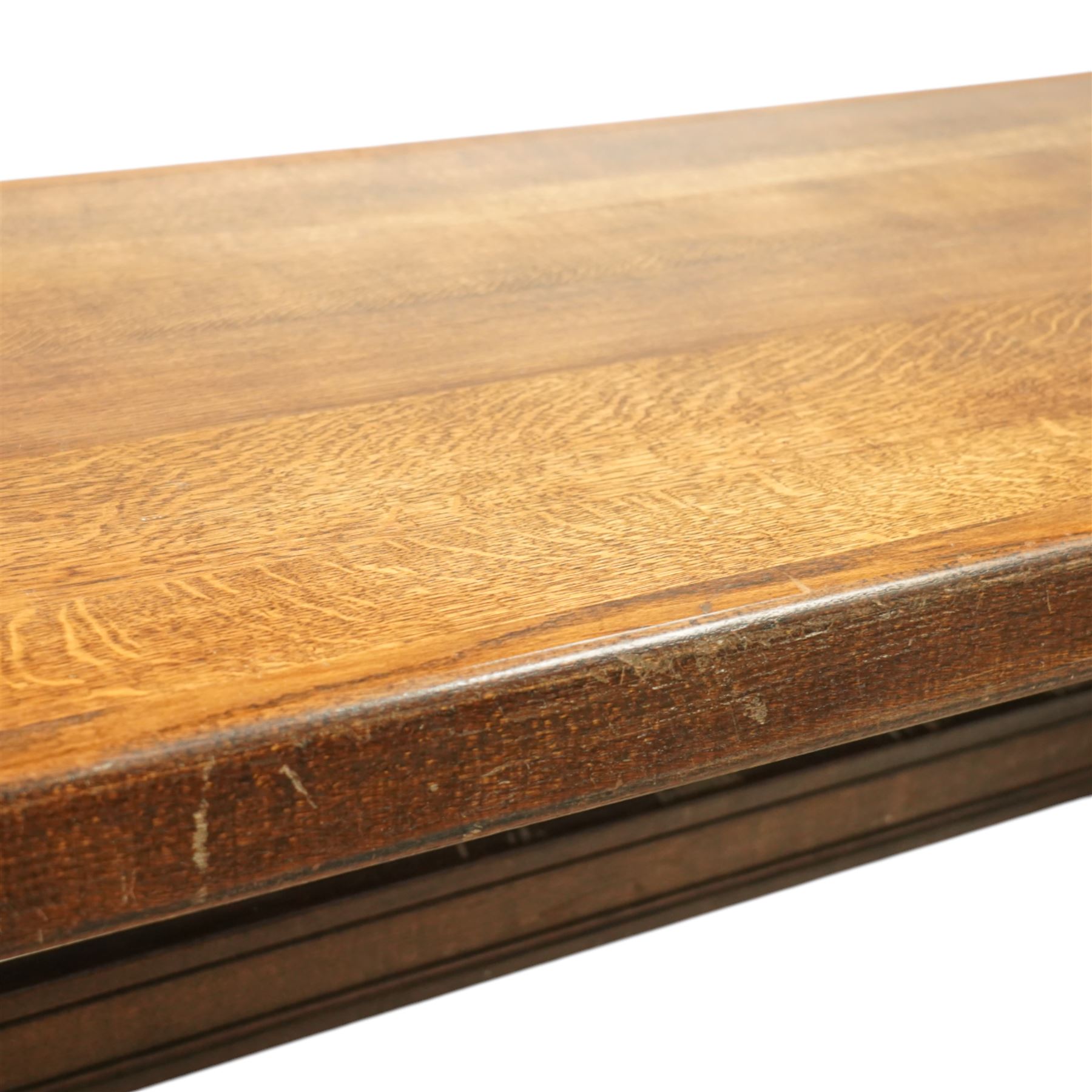 Early 20th century French oak refectory table, the thick rectangular top with cleated ends above shaped lyre-form trestle supports, united by a central stretcher, on broad scrolled feet, displaying well-figured quarter sawn grain across the top