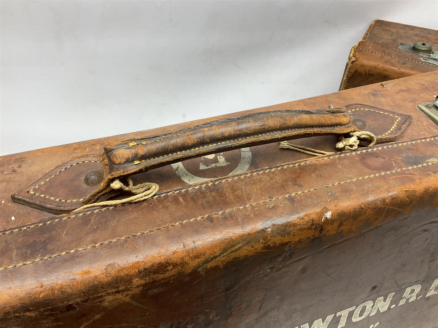 Early 20th century leather suitcase marked to the top 'Major P.M. Newton R.E. Crossways, Bridlington, East Yorkshire' 60 x 40cm; another similar leather suitcase marked W.D. to the lid; three post-WW2 respirators; and three unopened pairs of British Army N.B.C. (Nuclear Biological Chemical) No.1 Mk.III Trousers Protective (8)