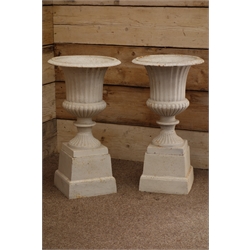 Pair classical style antique finish garden urns on stepped plinths, H65cm  