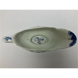 Large 18th century Lowestoft sauce boat, circa 1770, the body decorated with Hughes type floral moulding, and painted in underglaze blue with an Oriental landscape, and foliate sprigs, L23cm