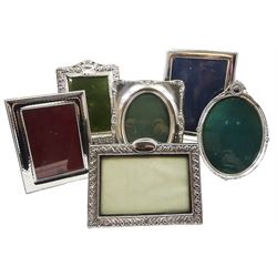 Six silver mounted photograph frames, to include modern example of plain rectangular form with easel style support verso, hallmarked Carr's of Sheffield Ltd, Sheffield 1990, overall H22cm W17cm, aperture H17.5cm W13cm, a smaller modern rectangular example with soft planished finish, hallmarks worn and indistinct, Edwardian example with scrolling edge, hallmarked Birmingham 1906, makers mark partly worn and indistinct, early 20th century oval example with floral wreath and husk swag surmount, and two others