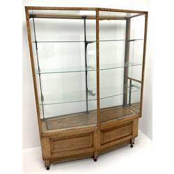 Early 20th century oak shop display cabinet, shaped front with three glass shelves, parquetry base 