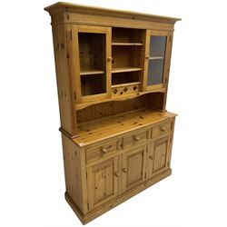 Traditional pine dresser, the rack fitted with two shelves flanked by glazed cupboards, the base with three drawers over three panelled cupboards