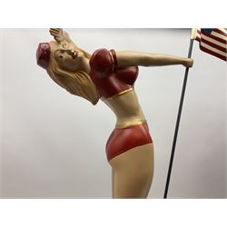 Composite Superman with cape, together with a composite female statue holding the American flag, tallest example H103cm