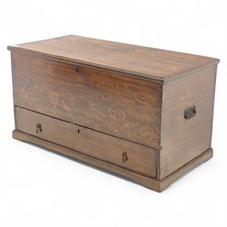 19th century oak blanket chest, rectangular hinged plank top with moulded edge, plain sides fitted with iron carrying handles, single full-width drawer to base with brass drop handles, on moulded plinth base