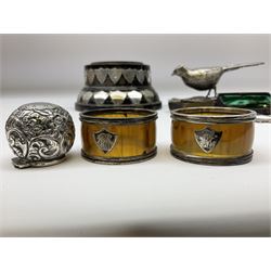 Group of silver, to include filled figure of a pheasant, hallmarked for London, pair of silver mounted horn napkin rings, miniature Edwardian bible with silver cover embossed with putti, Victorian silver brooch, ebonised plinth with applied inscribed silver shields, etc., together with two stick pins, one example with 9ct gold terminal 