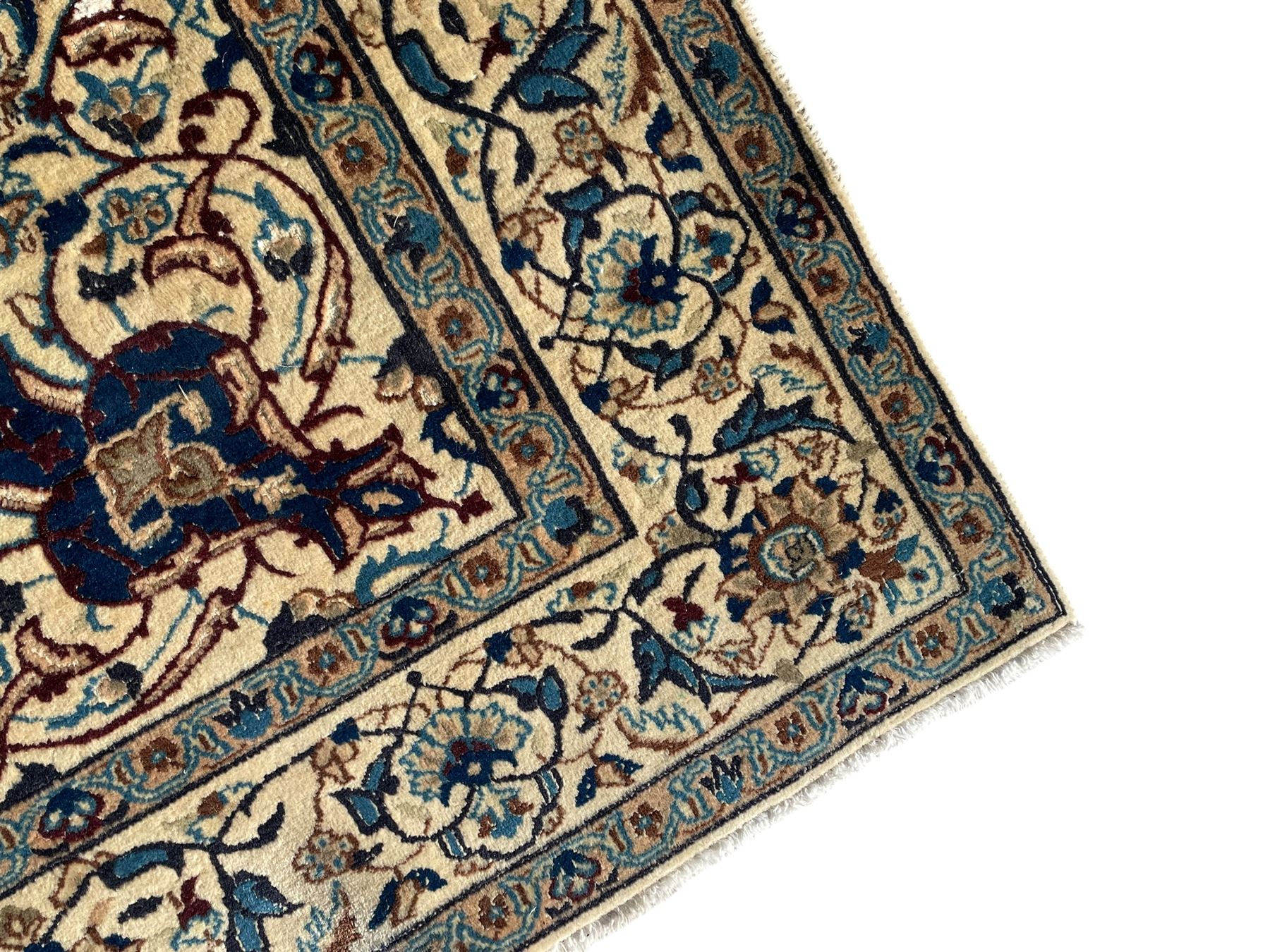 Persian Kashan ivory ground rug, wool with silk inlay, central floral rosette medallion surrounded by trailing flower heads and interlacing leafy branches, the repeating scrolling border decorated with palmettes, within guard stripes