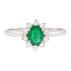 18ct white gold oval cut emerald and round brilliant cut diamond cluster ring, stamped 750