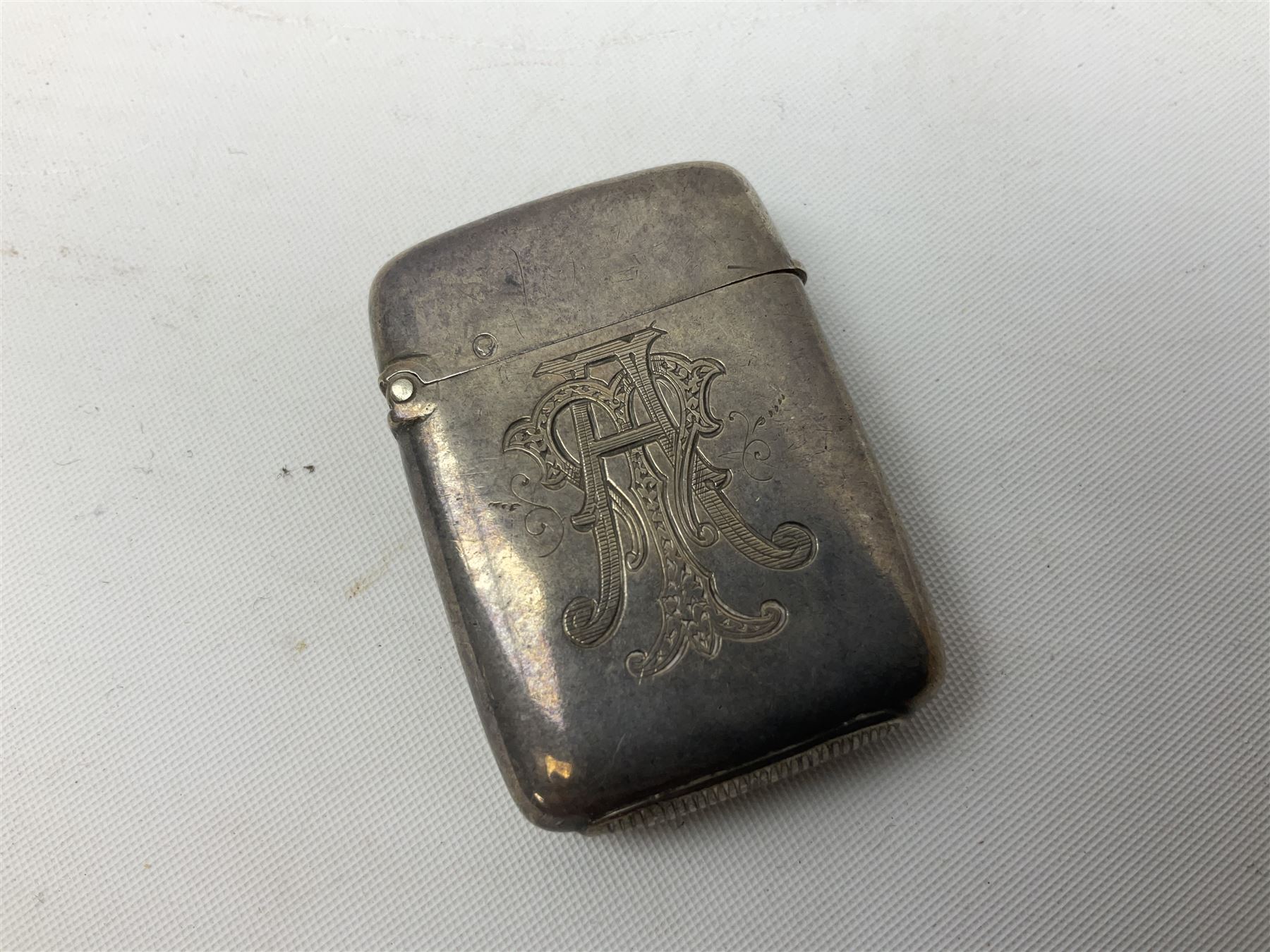 Victorian novelty brass vesta case modelled in the form of a pig holding a money bag, together with a silver vesta, hallmarked 