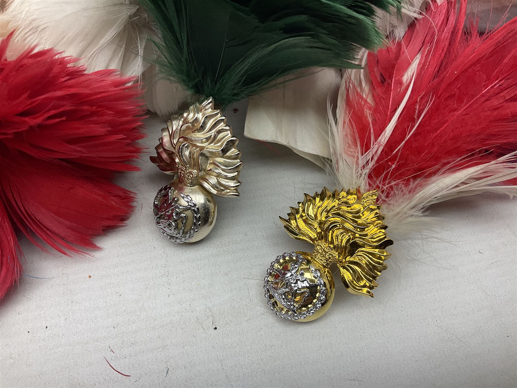 Quantity of military horse hair plumes and feather hackles, cloth stripes and regimental titles etc