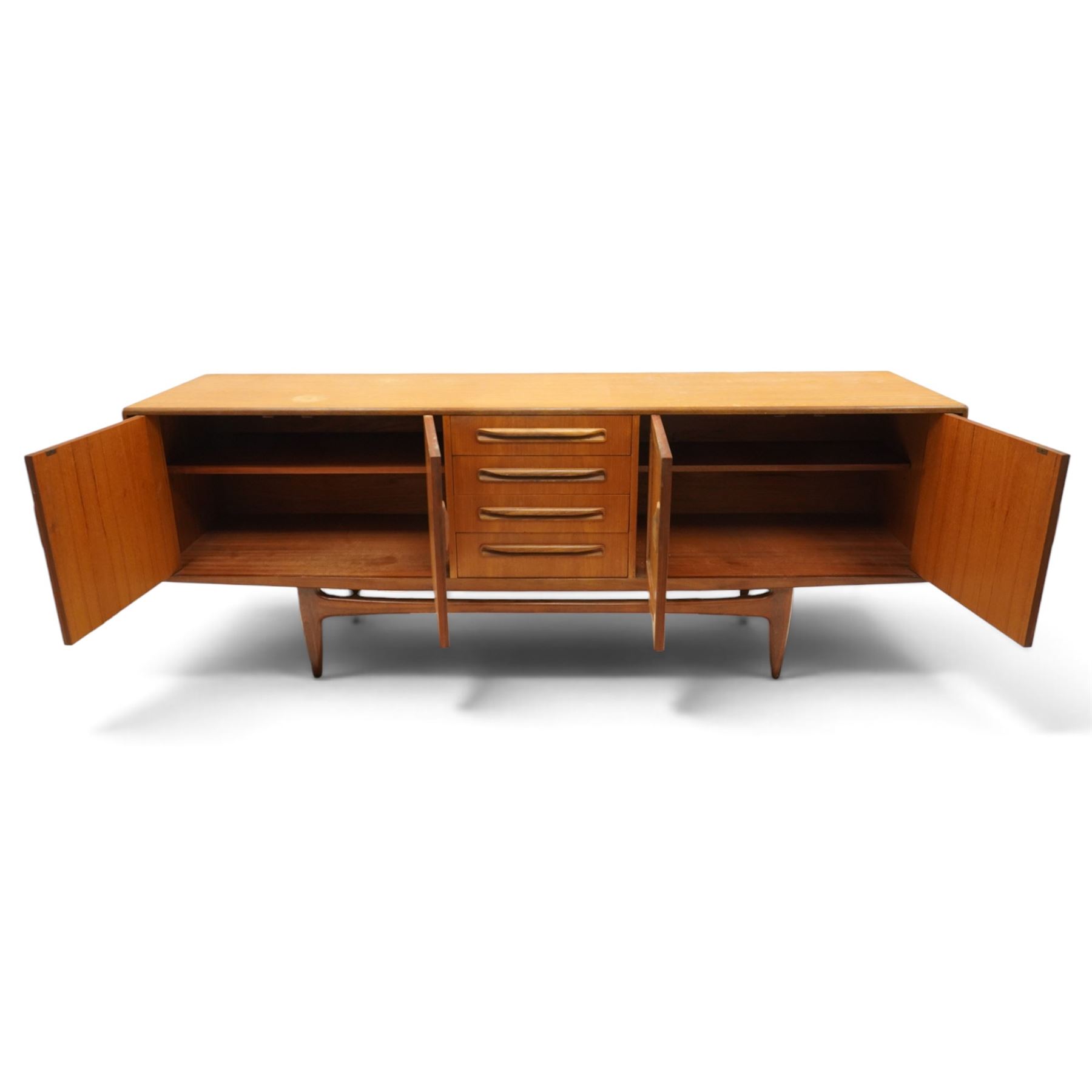 G-Plan - 'Fresco Long John' teak mid 20th century sideboard, a central bank of four drawers, flanked by twin cupboard doors, with recessed handles, on a tapering supports 